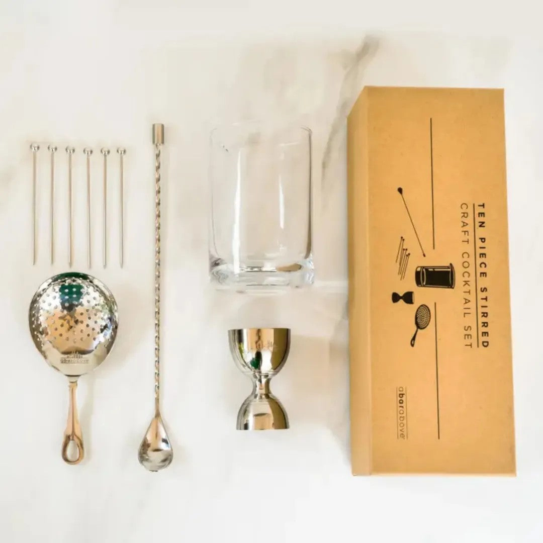All 10 pieces in the A Bar Above set: mixing glass, bell jigger, julep strainer, spiral bar spoon and six cocktail picks, with box.