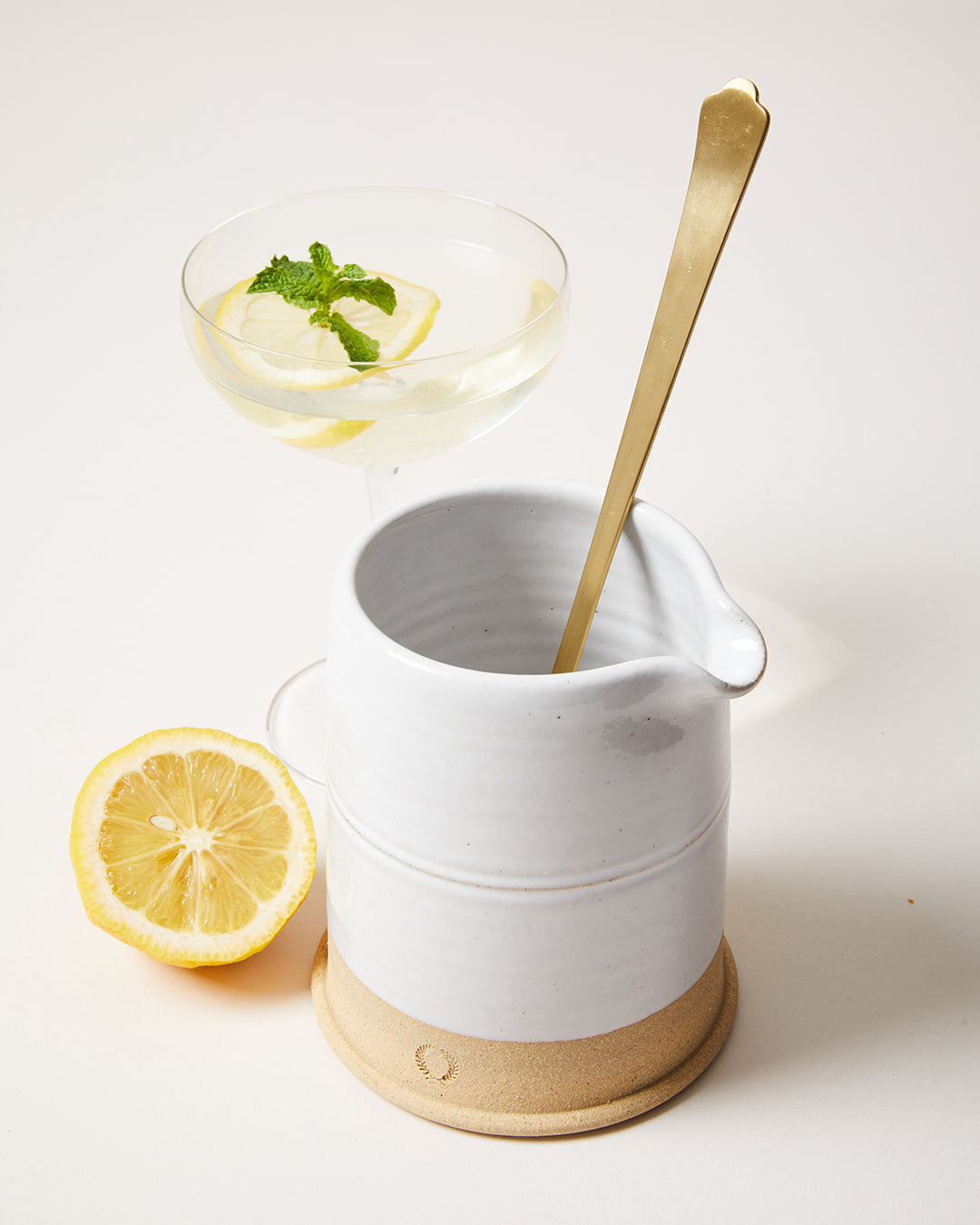 Countryman Cocktail Beaker styled with a gold bar spoon, lemon and coupe glass