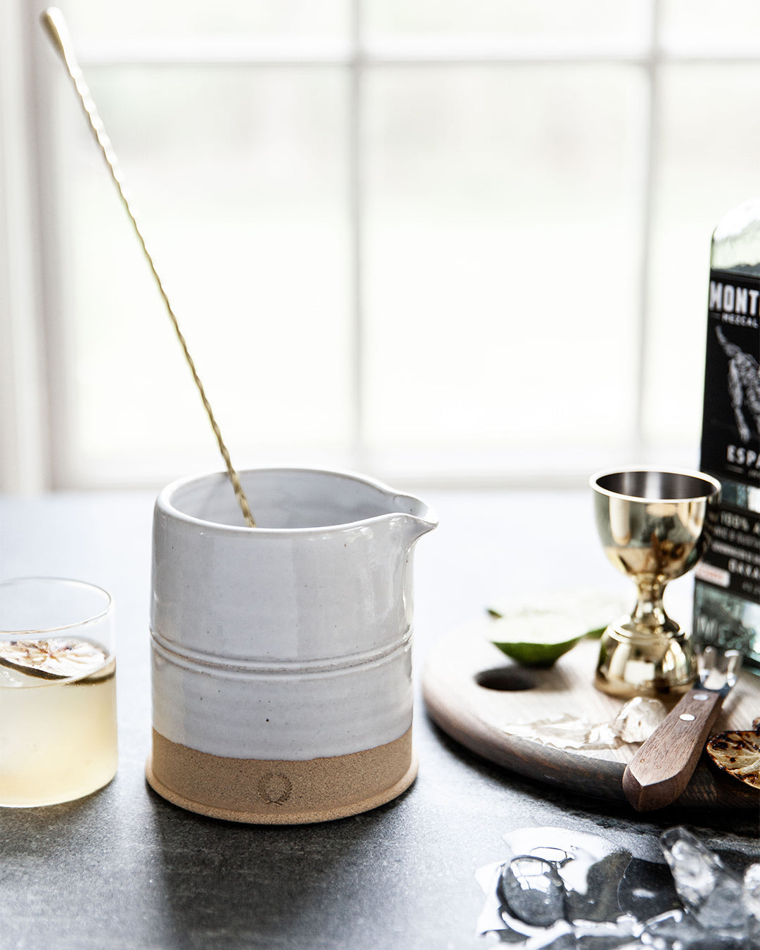 Countryman Cocktail Beaker styled on a home bar with a mixing spoon and cocktails
