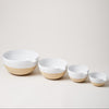 Four nested Farmhouse Pottery Pantry Bowls with white glaze and natural stoneware bases