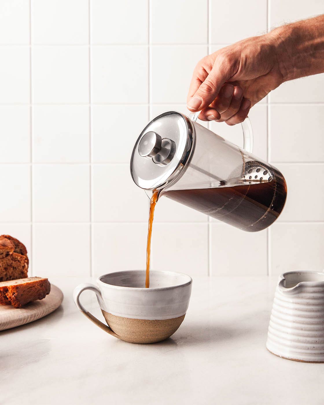 Coffee poured from a French press into a Farmhouse Pottery Pantry Mug