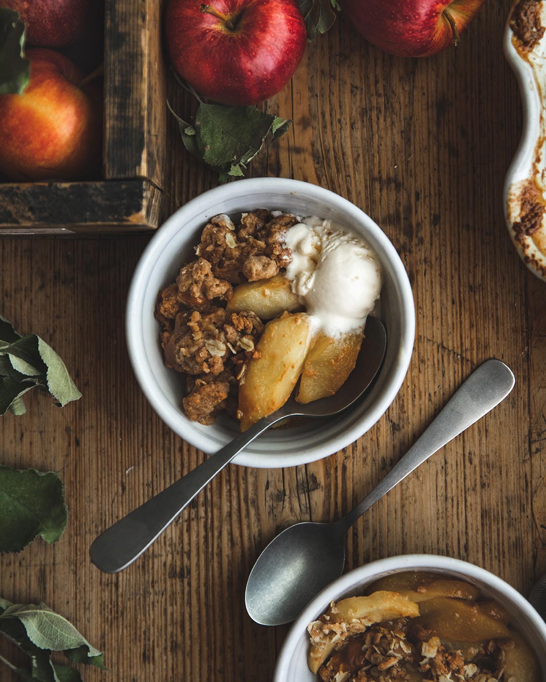 Farmhouse Pottery Silo Bowls serving fruit crisp and ice cream on a wooden table