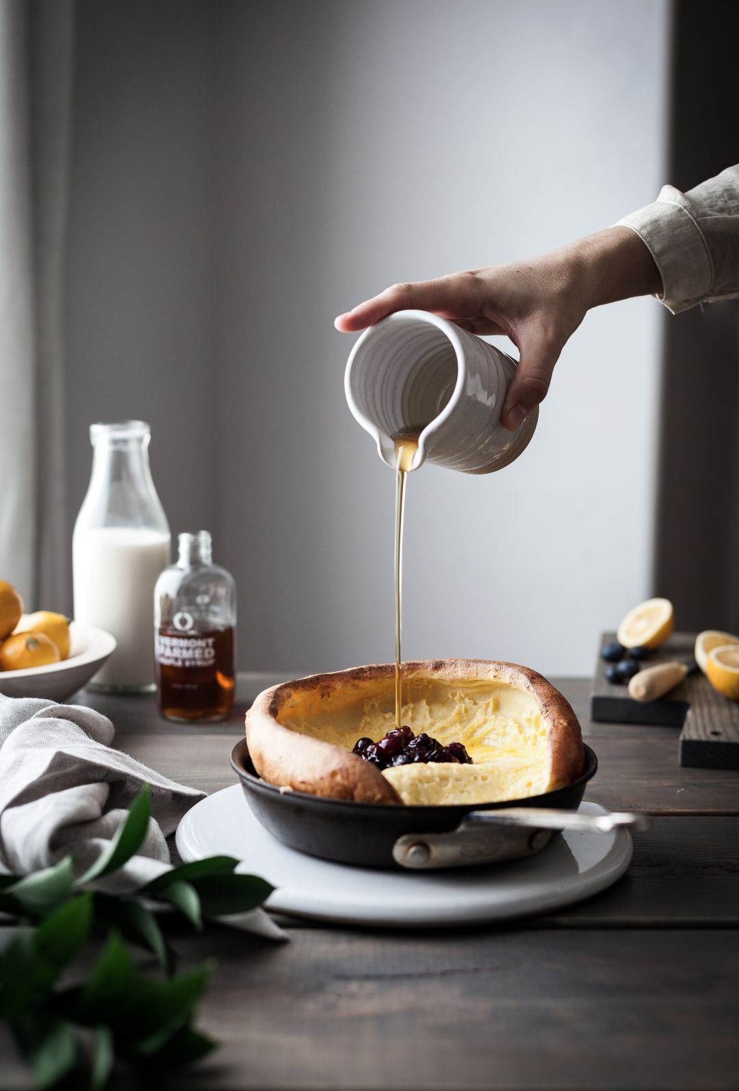 Farmhouse Pottery Silo Pitcher pouring syrup over a Dutch baby pancake; food and accessories are not included.