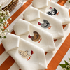 The Country Table: embroidered hen napkins and striped cotton canvas placemats, made in Brazil